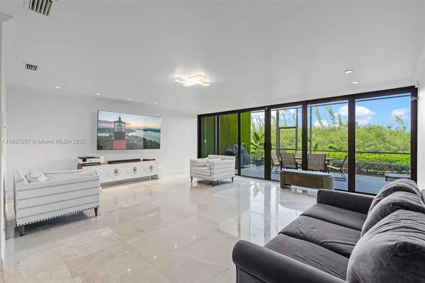 a living room with furniture and a piano