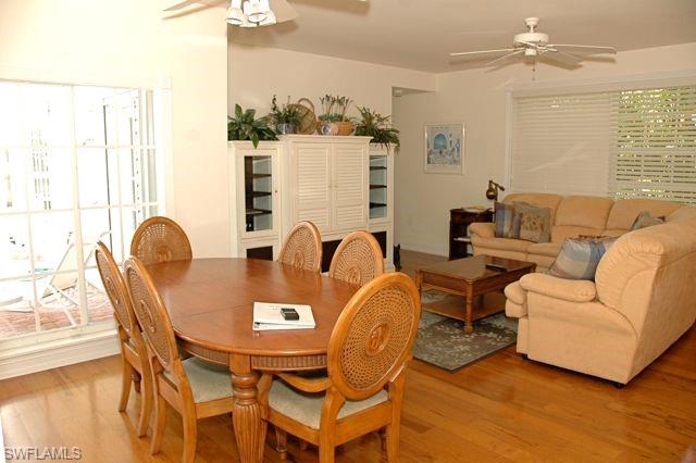 590 East Lake Drive Naples, FL 34102 - Photo 2 of 11 Dining room with ceiling fan and light wood-type flooring