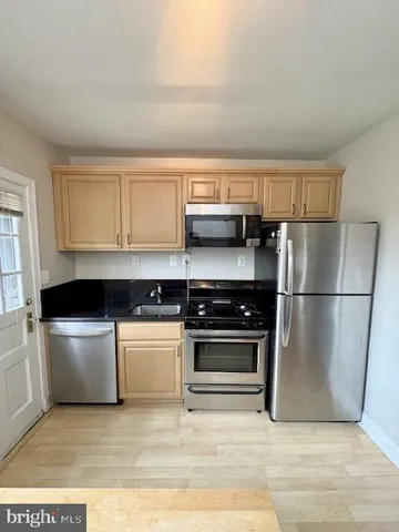 a kitchen with a stove a microwave and a refrigerator