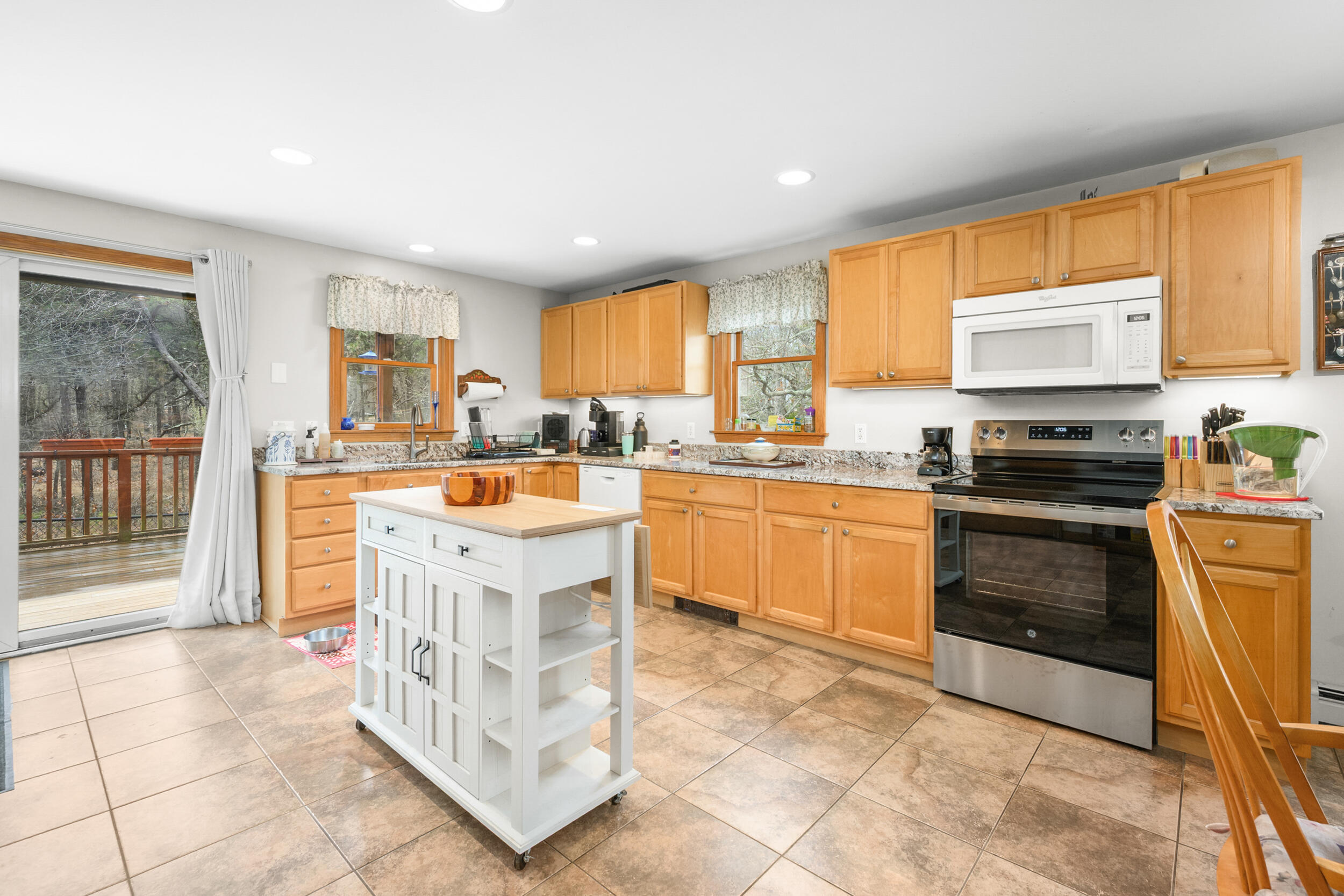2 Short Lots Lane Truro, MA 02666 - Photo 9 of 61 a kitchen with stainless steel appliances granite countertop a stove top oven a sink a counter top space cabinets and a window