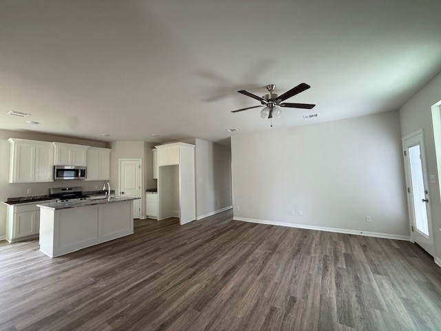 2602 Falcon Ridge Drive Bryan, TX 77803 - Photo 5 of 15 a view of a kitchen with a sink a ceiling fan and wooden floor