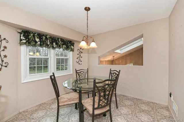 a view of a dining room with furniture and window