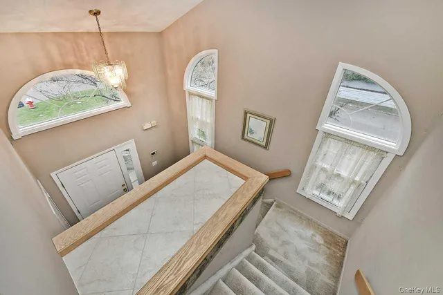 a view of living room with furniture and a mirror