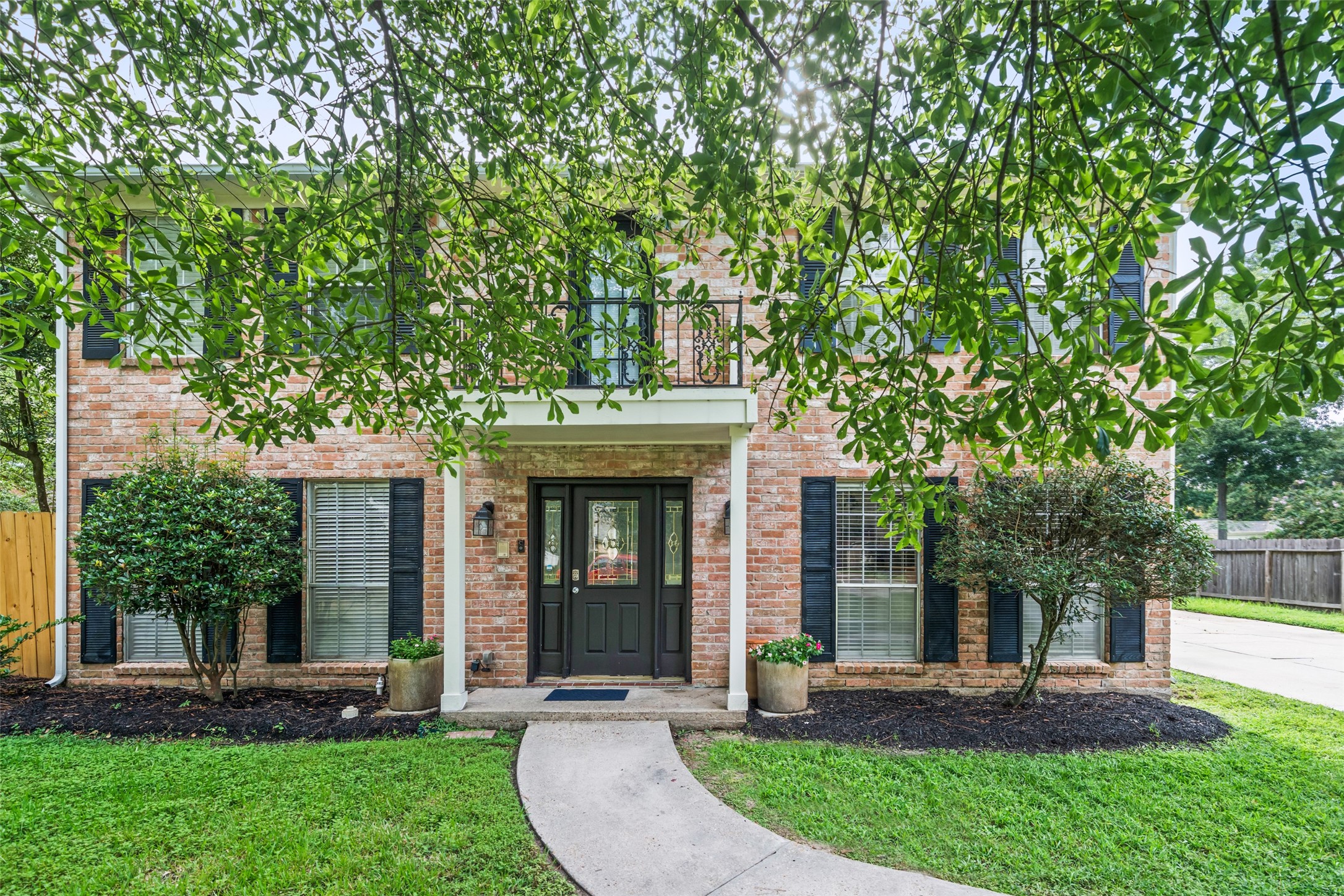 600 Hampton Hall Lane Conroe, TX 77302 - Photo 2 of 32 a front view of a house with a yard and a large tree