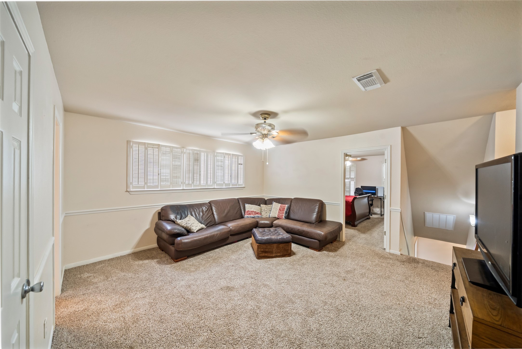 600 Hampton Hall Lane Conroe, TX 77302 - Photo 21 of 32 a living room with furniture a ceiling fan and a window