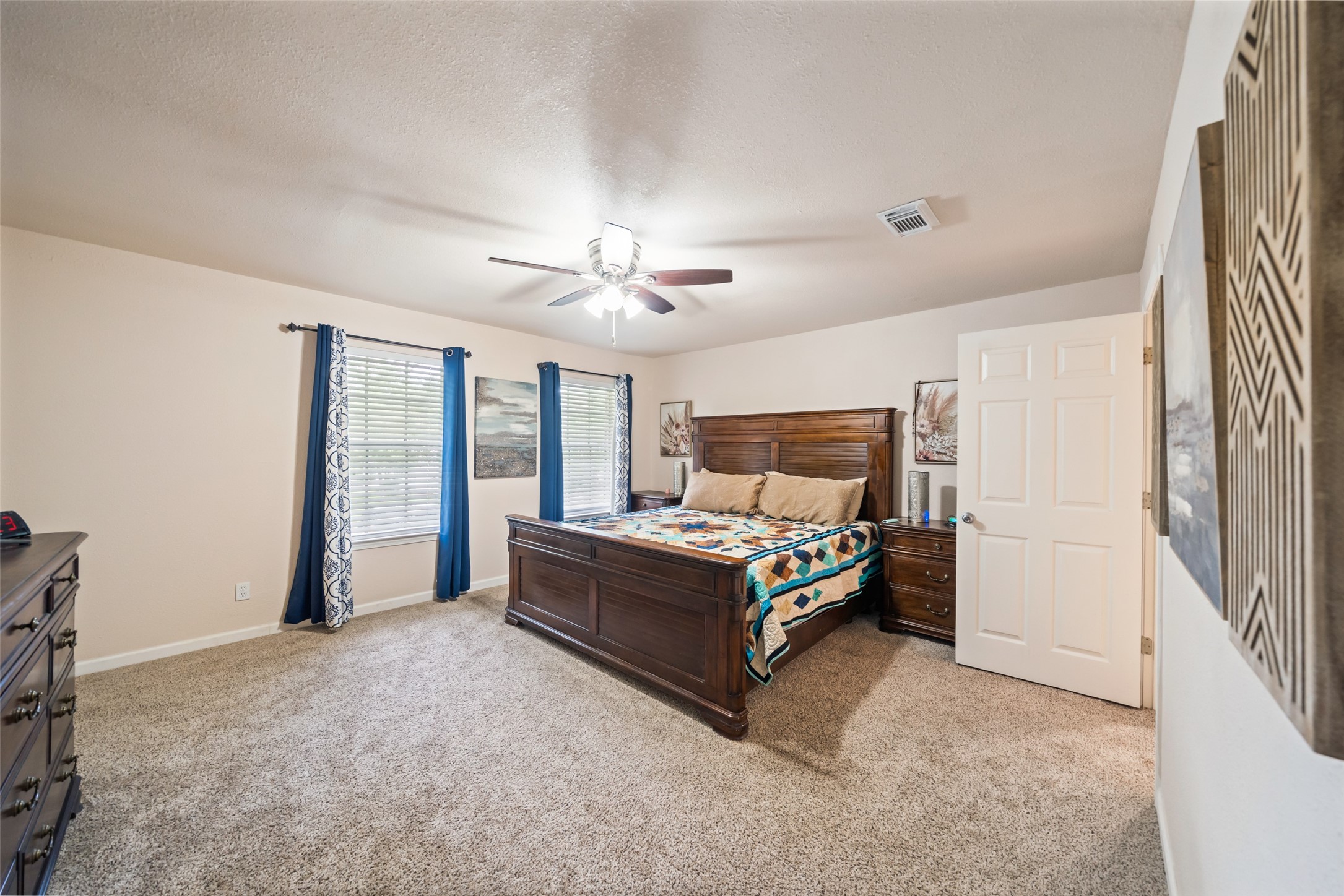600 Hampton Hall Lane Conroe, TX 77302 - Photo 23 of 32 a bedroom with a bed and a chandelier