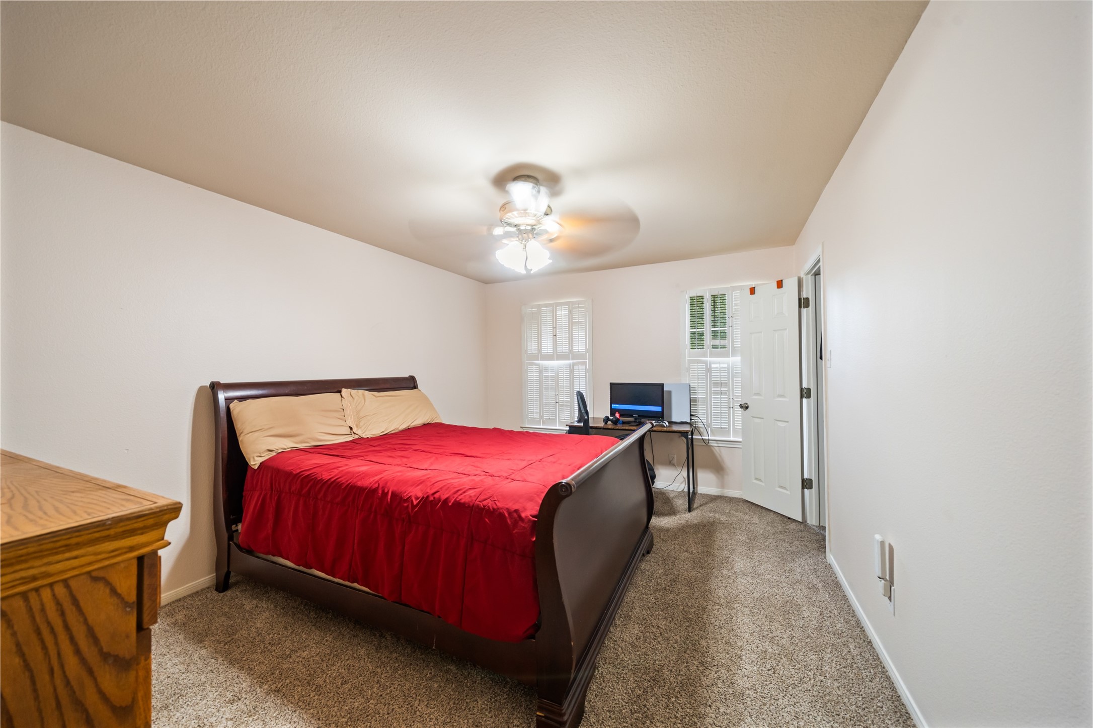 600 Hampton Hall Lane Conroe, TX 77302 - Photo 25 of 32 a spacious bedroom with a bed and a chandelier