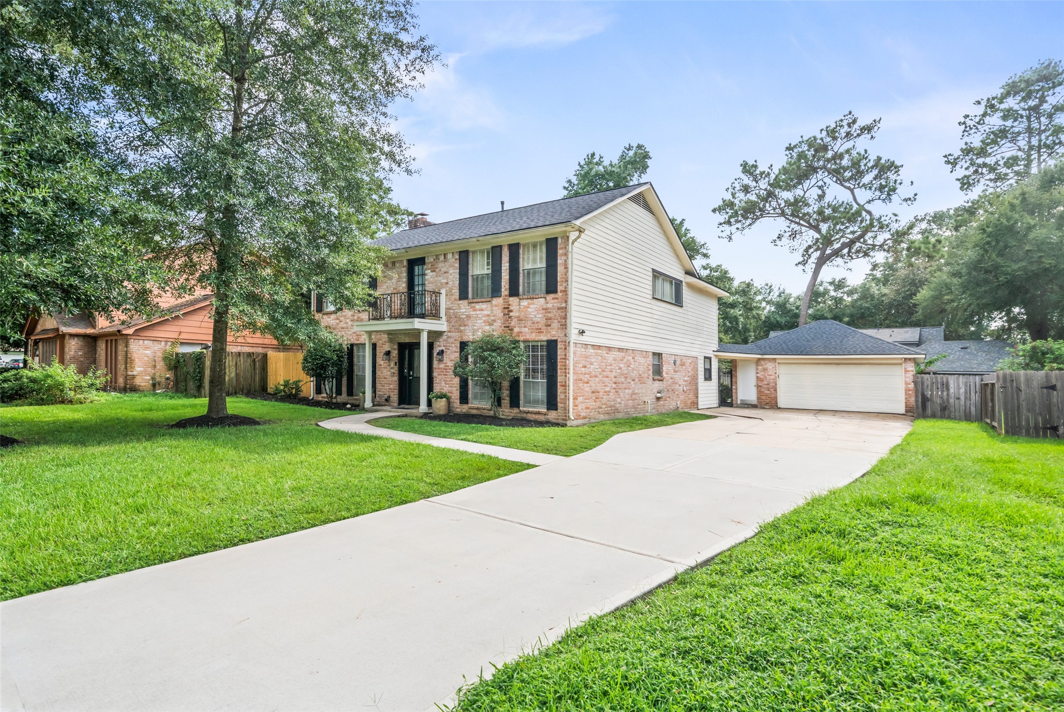 600 Hampton Hall Lane Conroe, TX 77302 - Photo 30 of 32 a front view of a house with a yard and trees