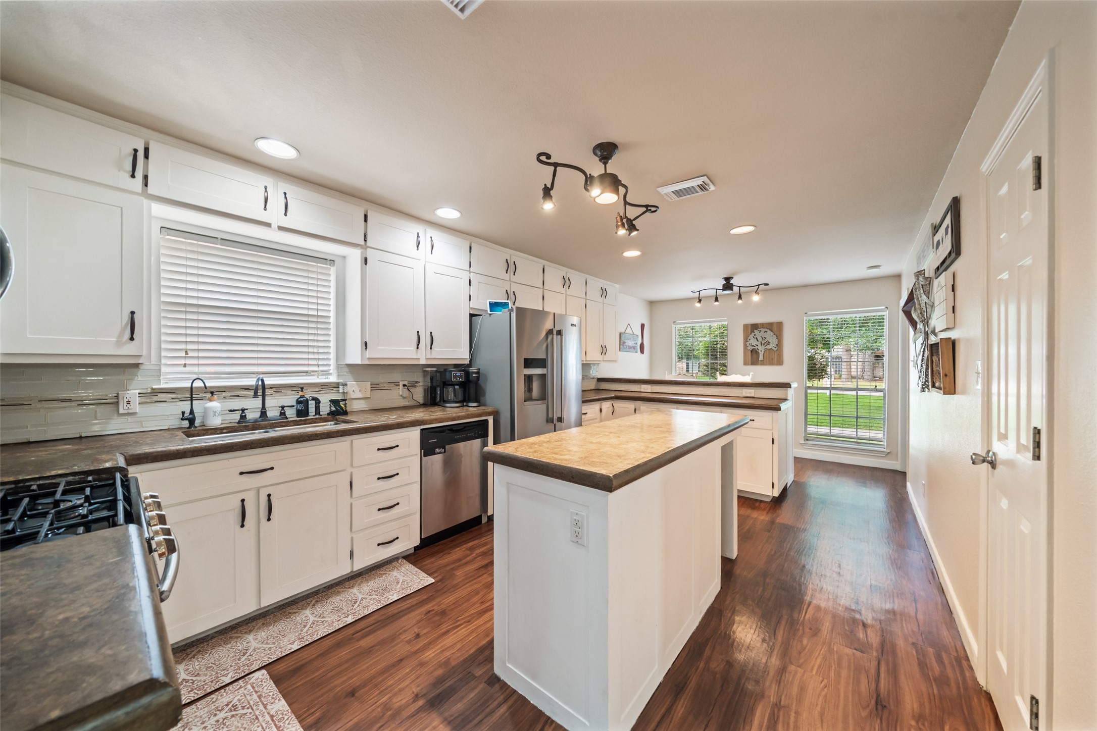 600 Hampton Hall Lane Conroe, TX 77302 - Photo 6 of 32 a kitchen with granite countertop a sink a counter top space stainless steel appliances and a window