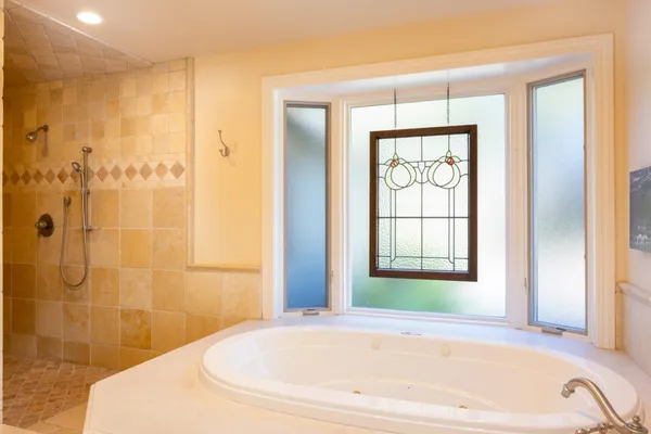 a bathroom with a bathtub and shower