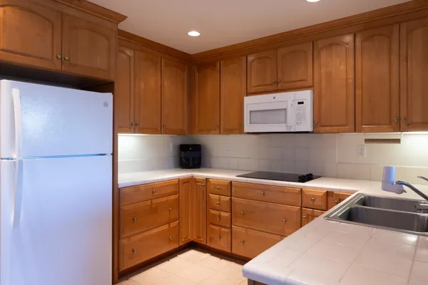 a kitchen with a refrigerator and cabinets