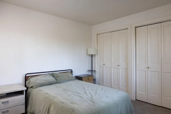 a bedroom with a bed and a shower