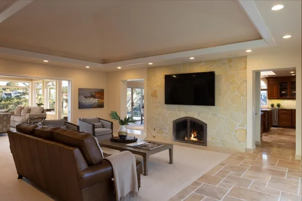 a living room with furniture a fireplace and a flat screen tv