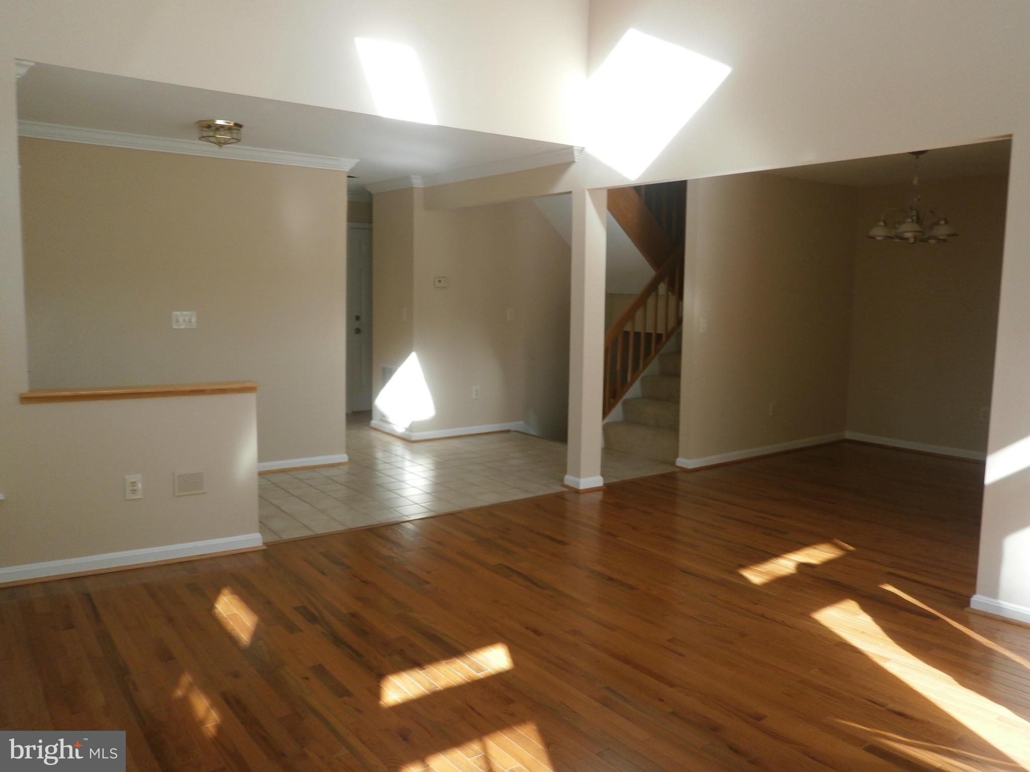 100 Spring Pl Way Annapolis, MD 21401 - Photo 4 of 15 a view of an empty room with wooden floor