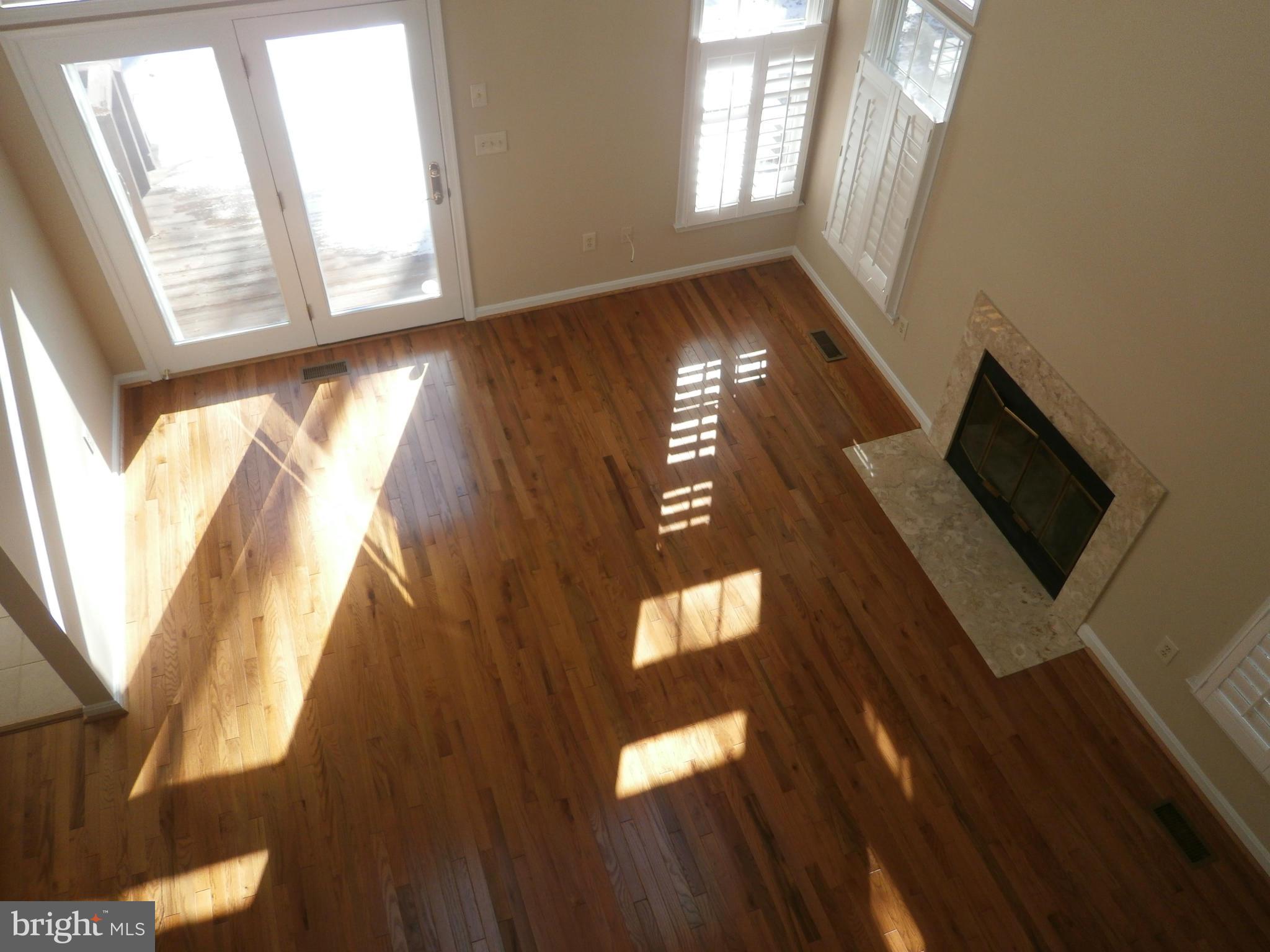 100 Spring Pl Way Annapolis, MD 21401 - Photo 5 of 15 a view of an empty room with wooden floor and a window