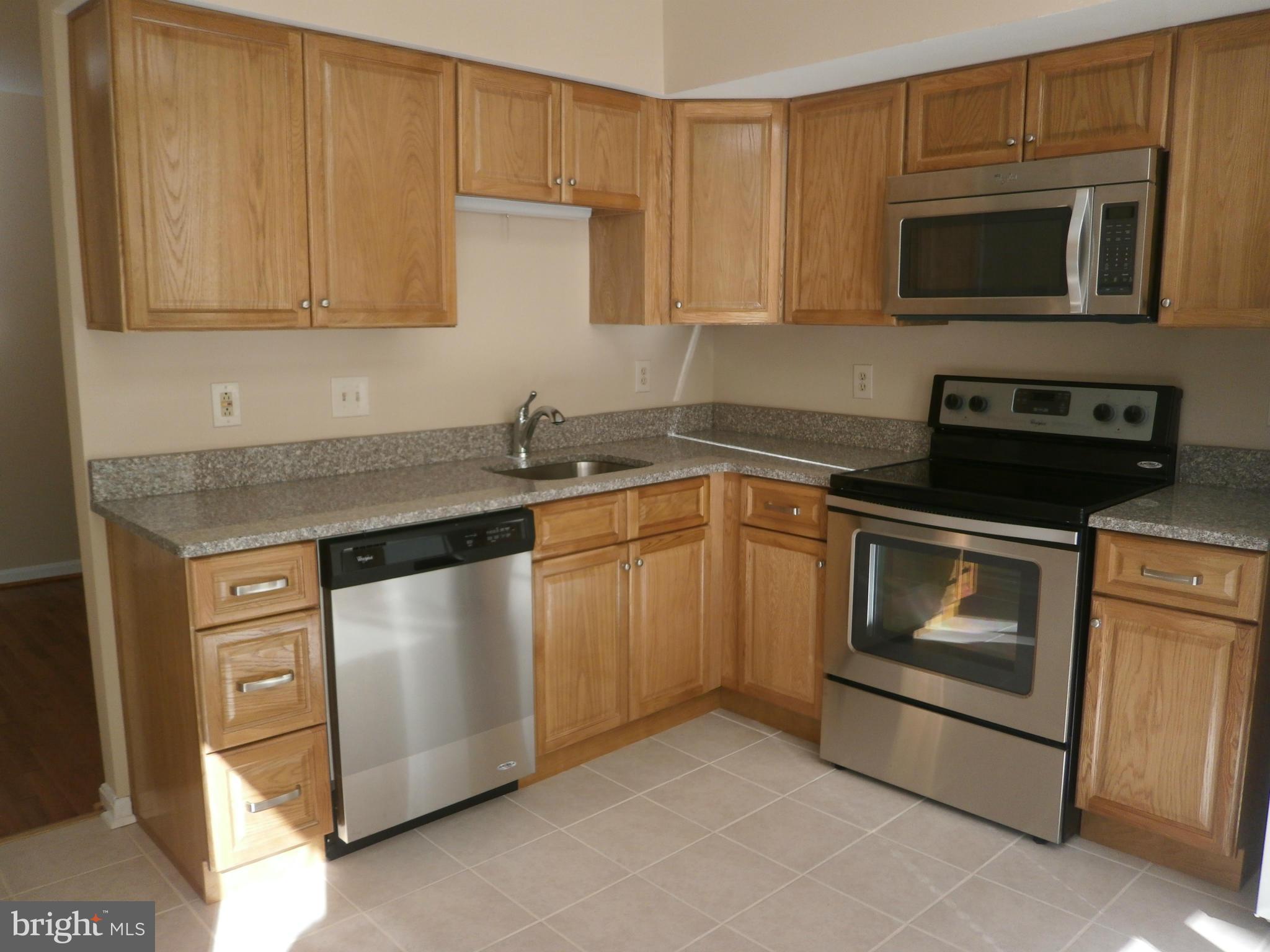 100 Spring Pl Way Annapolis, MD 21401 - Photo 6 of 15 a kitchen with stainless steel appliances granite countertop a stove microwave and sink