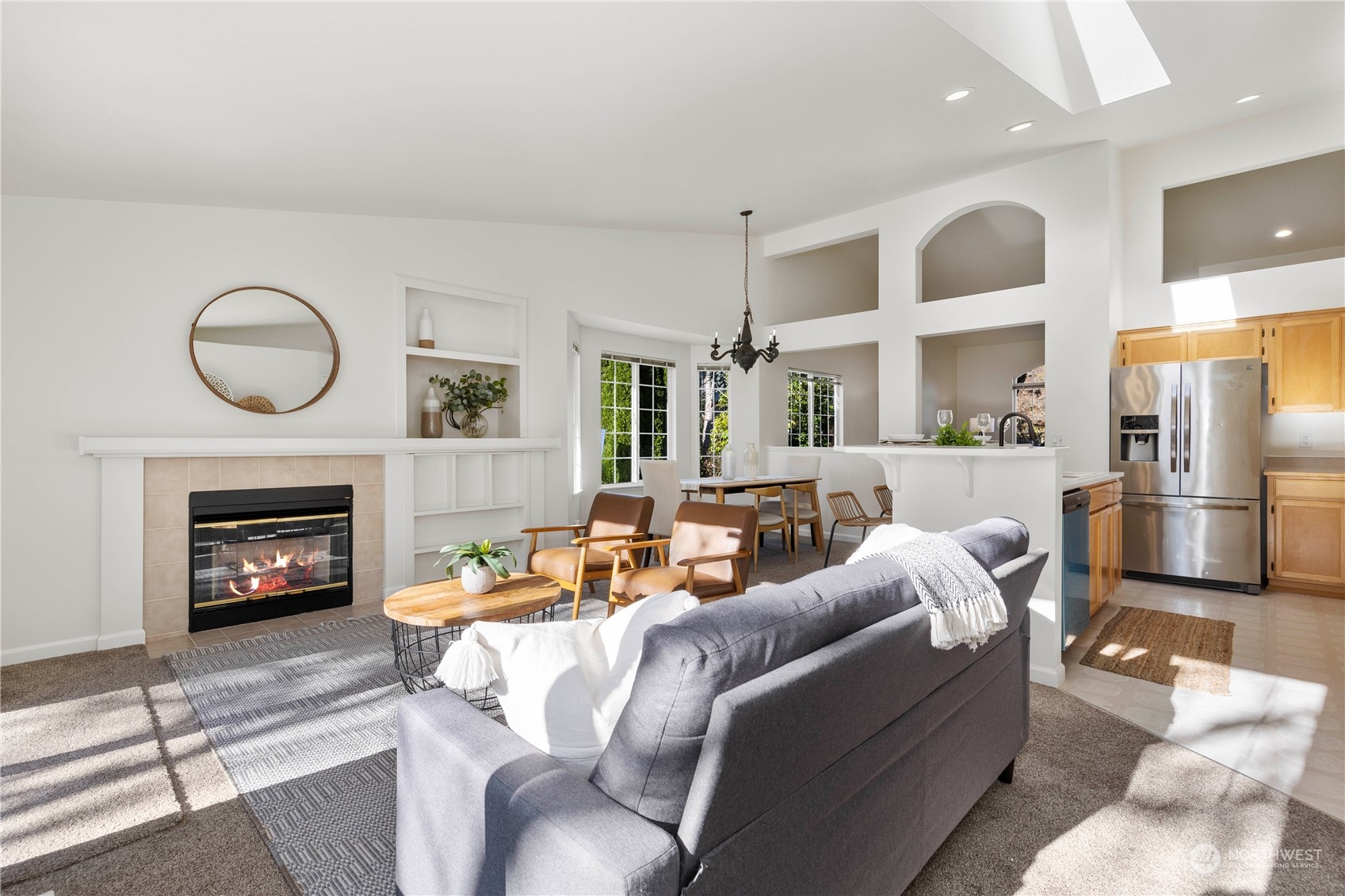 112 172nd Place Southeast Bothell, WA 98012 - Photo 14 of 30 a living room with furniture a fireplace and kitchen view