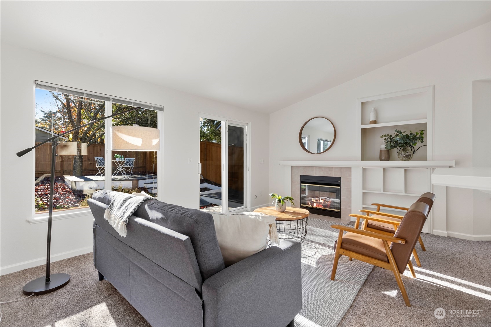 112 172nd Place Southeast Bothell, WA 98012 - Photo 15 of 30 a living room with furniture a fireplace and a large window