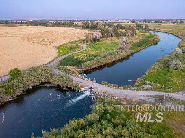 6891 West 2000 South Rexburg, ID 83440 - Photo 46 of 50 Aerial view of property and surrounding area featuring a large body of water and rural landscape