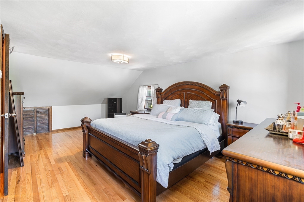 3 Fitz Road Peabody, MA 01960 - Photo 16 of 34 a bedroom with bed and a chandelier