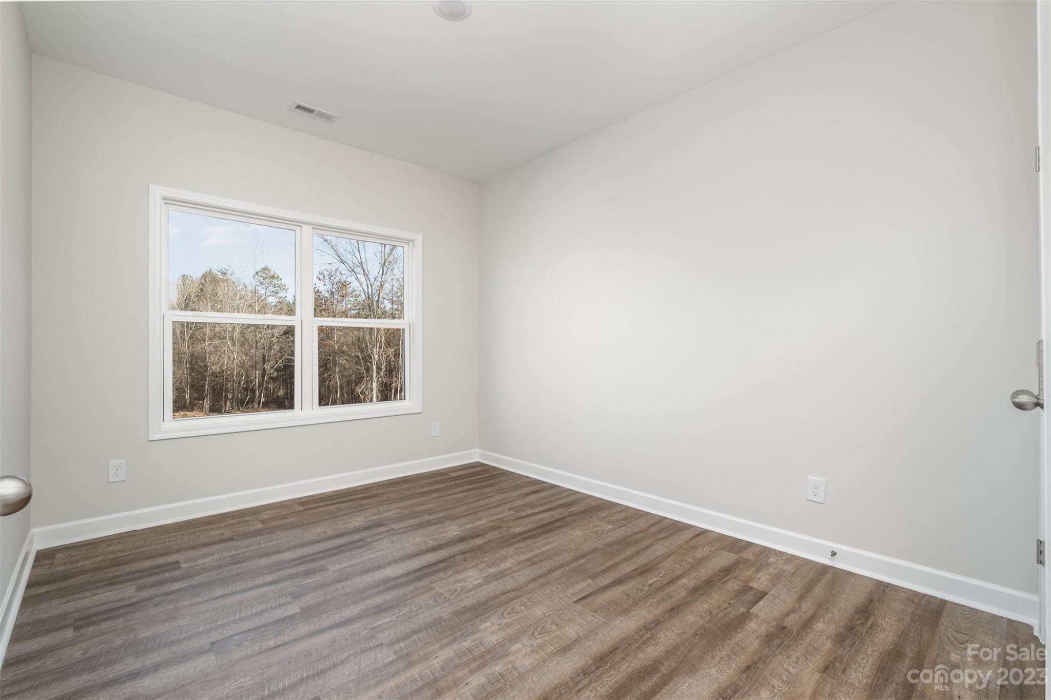 2870-2874 Fay Jones Road Denver, NC 28037 - Photo 19 of 23 wooden floor in an empty room with a window