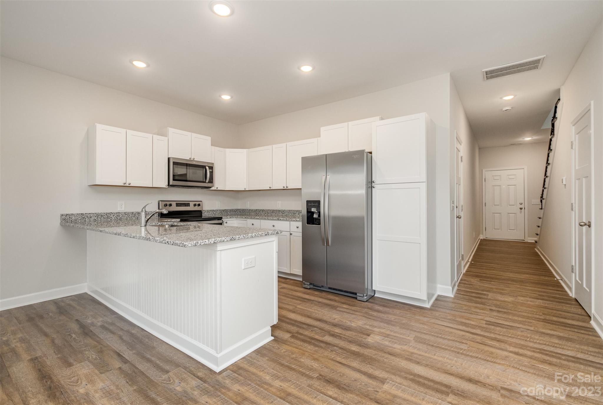 2870-2874 Fay Jones Road Denver, NC 28037 - Photo 4 of 23 a kitchen with a refrigerator a microwave and cabinets