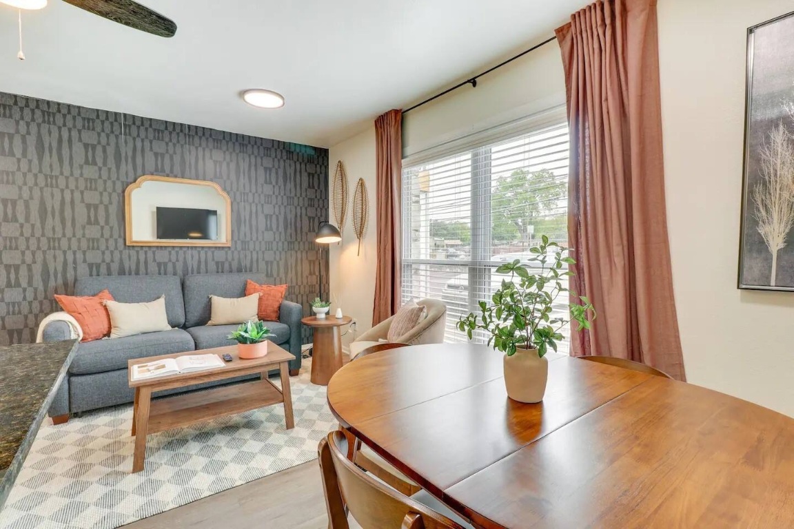 a living room with furniture potted plant and a window