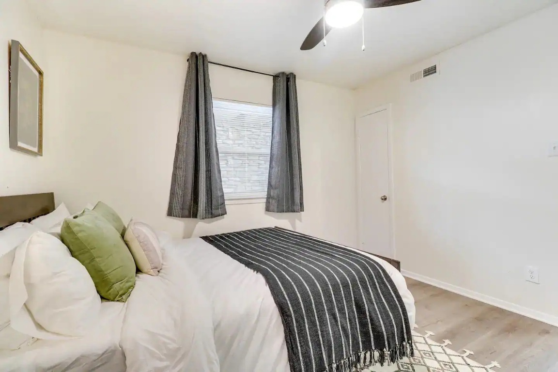 2401 Manor Road, Unit 129 Austin, TX 78722 - Photo 11 of 21 a bedroom with a bed and a window