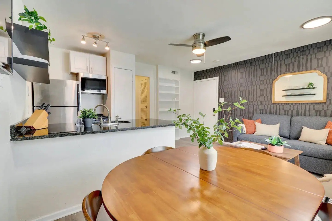 2401 Manor Road, Unit 129 Austin, TX 78722 - Photo 12 of 21 a dining room with furniture and a potted plant
