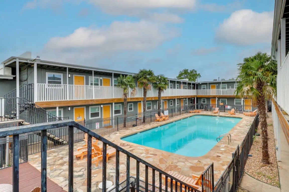 2401 Manor Road, Unit 129 Austin, TX 78722 - Photo 19 of 21 a view of a house with a swimming pool and sitting area