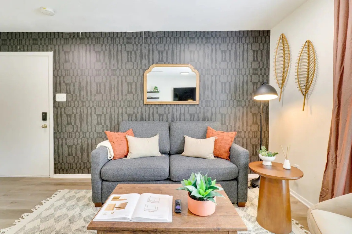 2401 Manor Road, Unit 129 Austin, TX 78722 - Photo 2 of 21 a living room with furniture and a fireplace