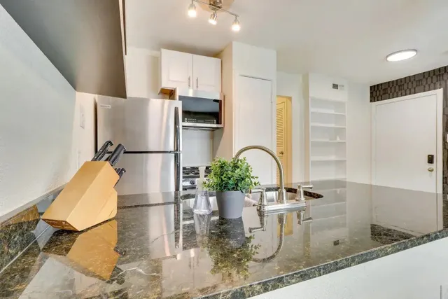 a kitchen with a refrigerator and a sink