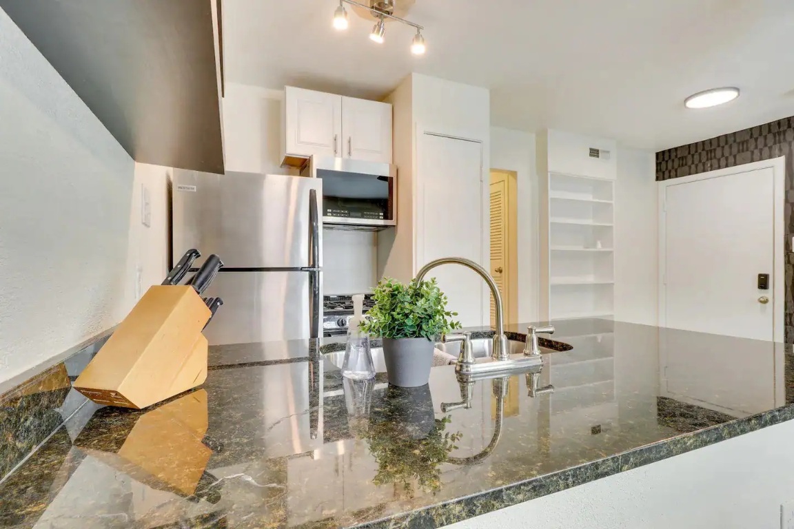2401 Manor Road, Unit 129 Austin, TX 78722 - Photo 21 of 21 a kitchen with a refrigerator and a sink