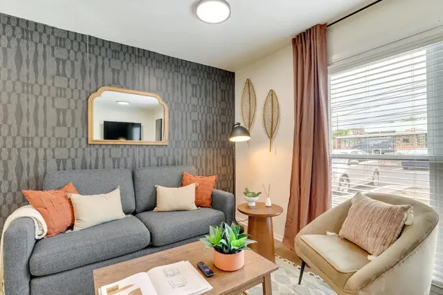 a living room with furniture and a large window