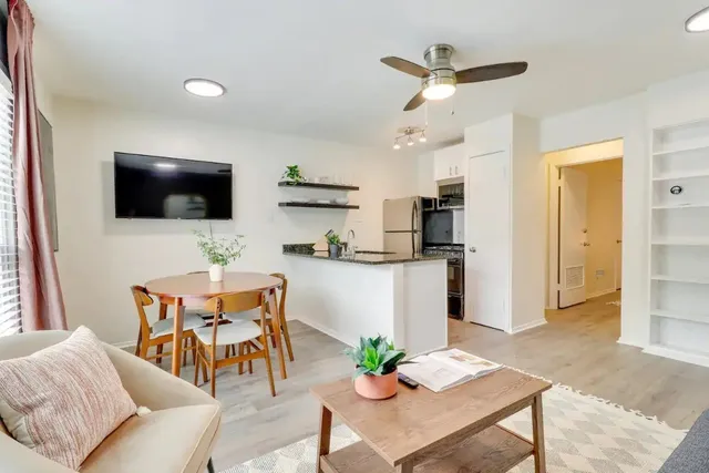 a living room with furniture and a flat screen tv