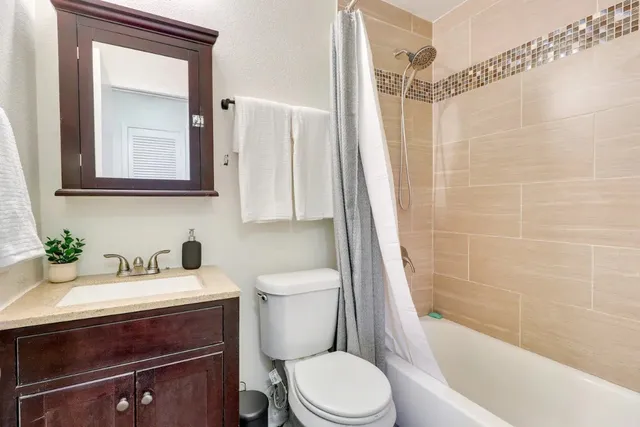 a bathroom with a sink a toilet and a bathtub