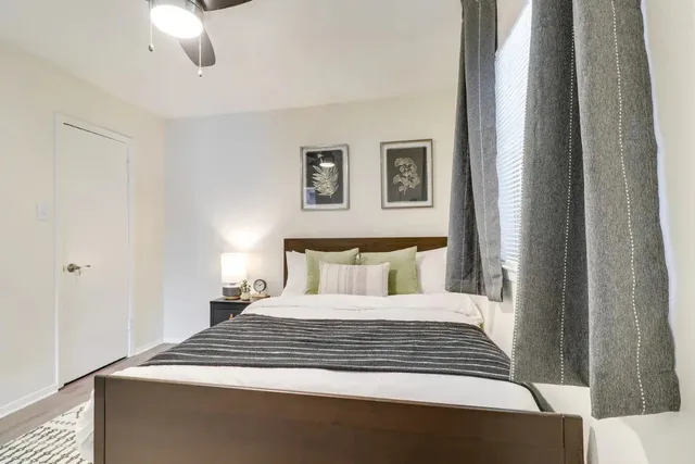 a bedroom with a large bed and a chandelier