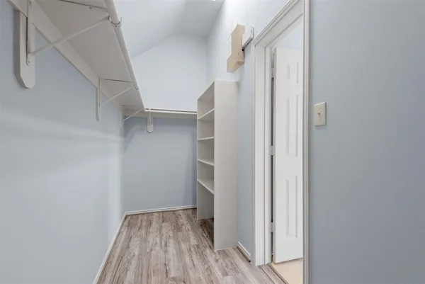 a bathroom with a tub sink shower and mirror