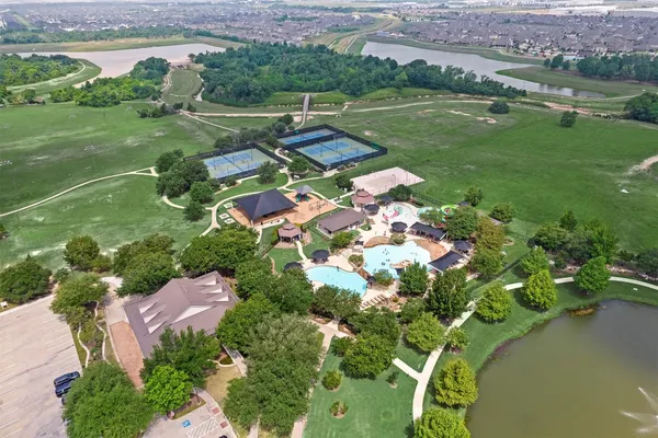 an aerial view of residential house with outdoor space and parking