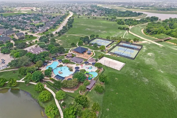 an aerial view of a house with a yard basket ball court and outdoor seating