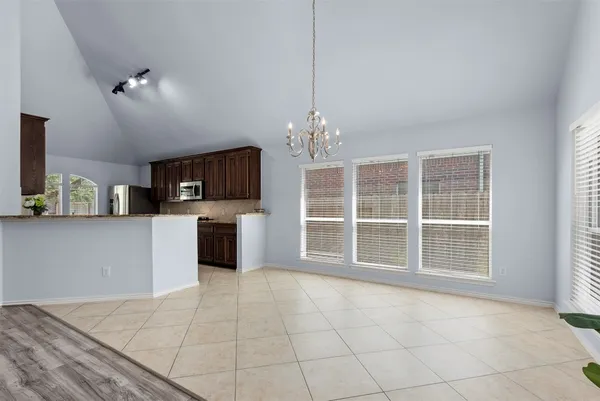 a view of a kitchen with a sink a fireplace and wooden floor