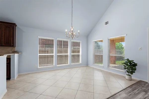 a view of an empty room with a kitchen