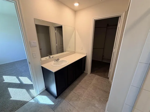 a bathroom with a sink vanity and mirror