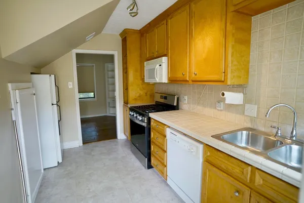 a kitchen that has a sink and a stove in it