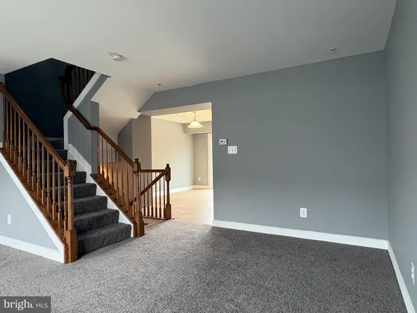 a kitchen with stainless steel appliances granite countertop a refrigerator a stove and a sink with wooden floor