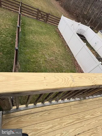 an empty room with windows and a chandelier fan