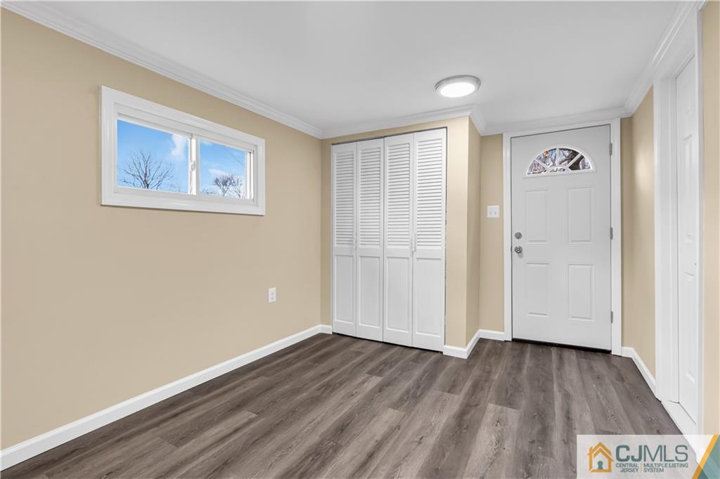 9 Nancy Circle Edison, NJ 08817 - Photo 12 of 38 an empty room with wooden floor and windows