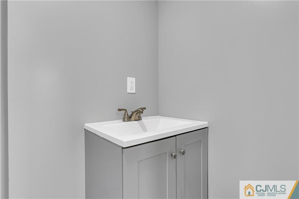 9 Nancy Circle Edison, NJ 08817 - Photo 14 of 38 a bathroom with a sink and mirror