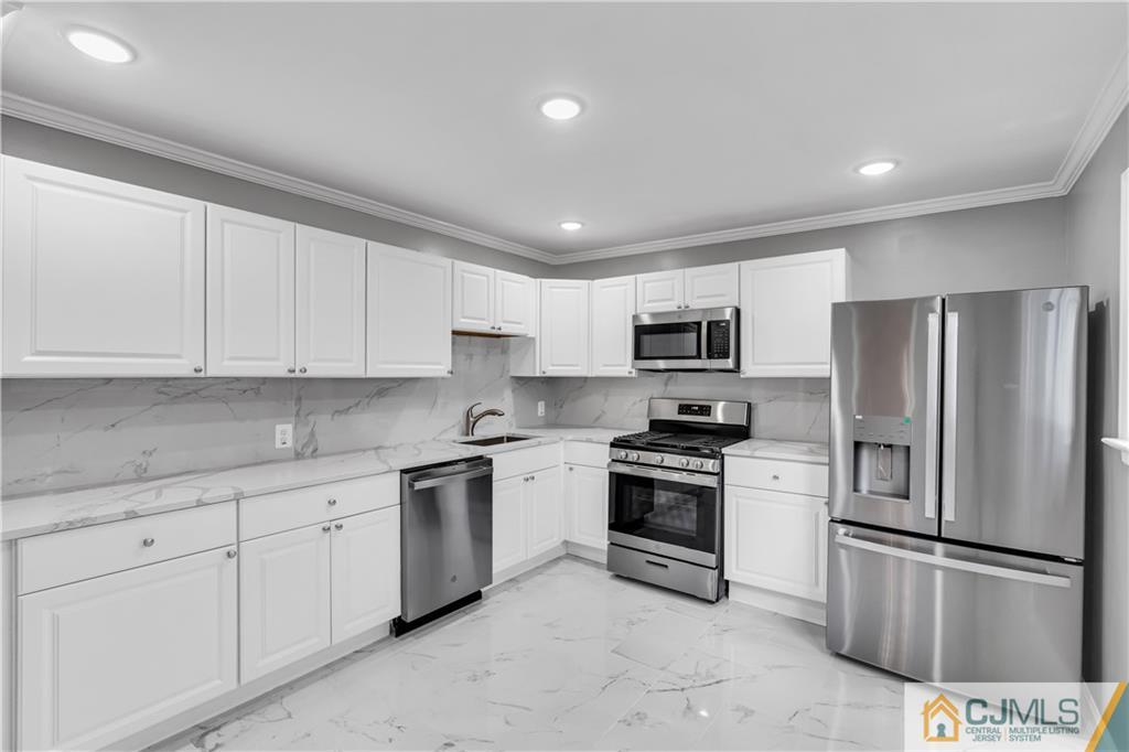 9 Nancy Circle Edison, NJ 08817 - Photo 19 of 38 a kitchen with stainless steel appliances granite countertop a stove a sink and a refrigerator