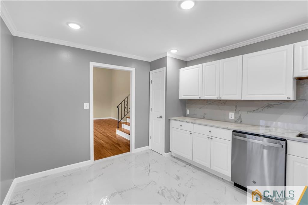 9 Nancy Circle Edison, NJ 08817 - Photo 22 of 38 a kitchen with granite countertop white cabinets and white appliances